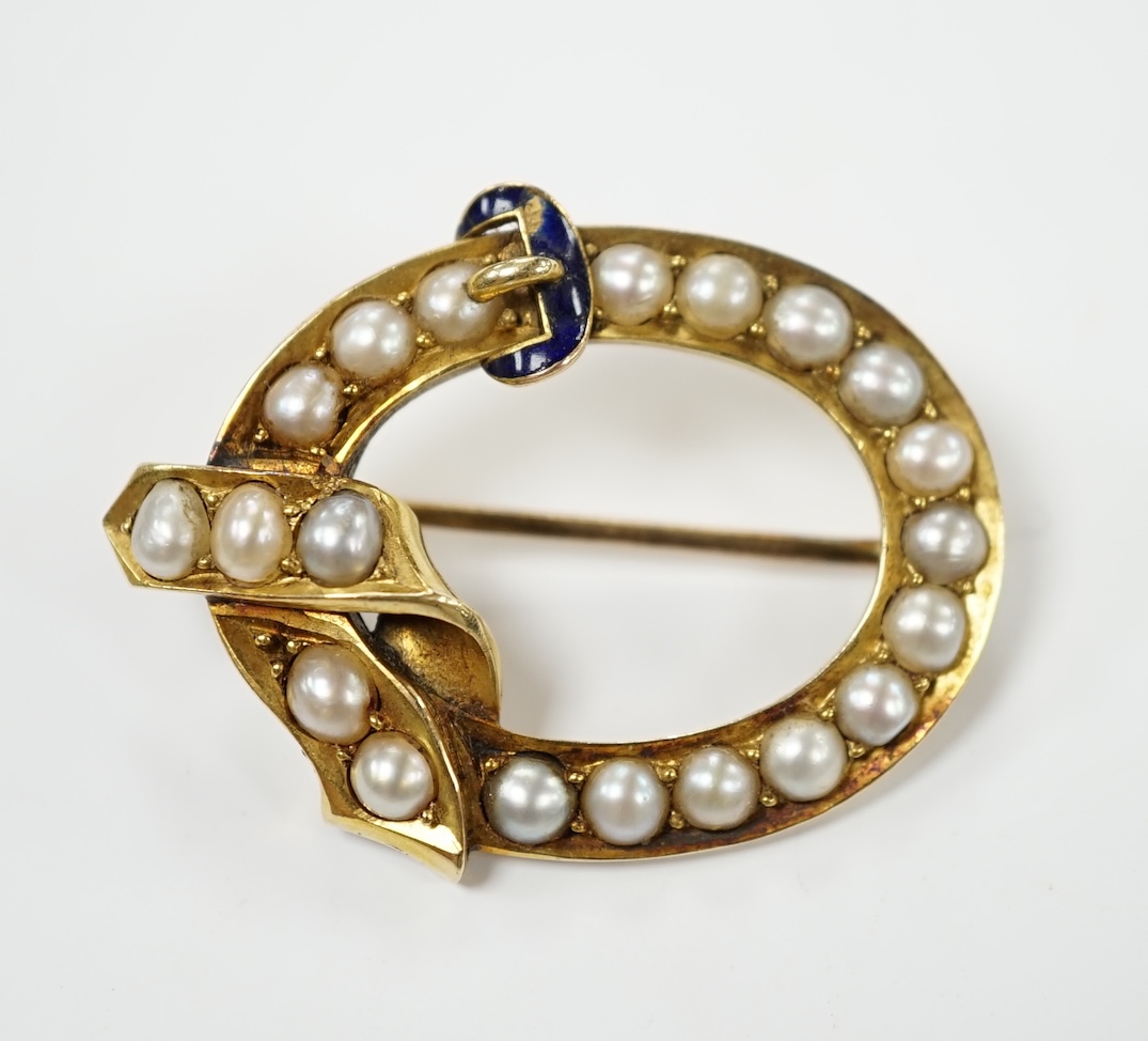 A late Victorian yellow metal, split pearl and enamel set open work buckle brooch, 34mm, gross weight 7.6 grams. Condition - fair to poor